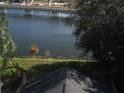 View of a lake with a bridge and lush trees at 8692 Foley Dr, Orlando, FL 32825