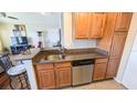 Kitchen with granite countertops, stainless steel appliances, and breakfast bar at 1065 S Hiawassee Rd # 1428, Orlando, FL 32835