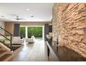 Open living area with stone wall and backyard access at 1429 Chapman Cir, Winter Park, FL 32789