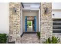 Elegant entryway with blue doors and stone pillars at 1429 Chapman Cir, Winter Park, FL 32789