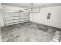 Empty attached garage with a light gray floor and an automatic garage door at 2642 Magnolia Cir, Lake Wales, FL 33898
