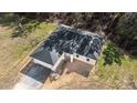 New construction home aerial view, showcasing a single-story house with a gray roof and paved driveway at 2642 Magnolia Cir, Lake Wales, FL 33898