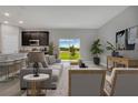Living room with gray sofa, sliding door to backyard, and view of water at 3577 Dahlia Dr, Lake Hamilton, FL 33851
