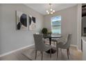 Dining area with gray chairs and black round table at 3577 Dahlia Dr, Lake Hamilton, FL 33851