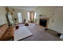 Living room with fireplace, plush seating and a large area rug at 4400 Thornbriar Ln # 201, Orlando, FL 32822