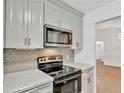 Modern kitchen with stainless steel appliances and marble countertops at 5105 Forestgreen W Dr, Lakeland, FL 33811