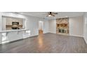Bright living room features a stone fireplace and hardwood floors at 5105 Forestgreen W Dr, Lakeland, FL 33811
