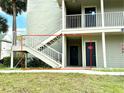 Exterior view of condo building's stairwell leading to unit entrance at 6142 Westgate Dr # 104, Orlando, FL 32835