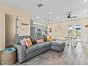 Bright living room featuring a large sectional sofa and an open floor plan at 8020 Shaker St, Kissimmee, FL 34747