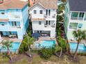 Aerial view of three-story townhouses with private pools and lush landscaping at 8020 Shaker St, Kissimmee, FL 34747