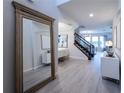 Bright and spacious entryway with a large mirror and view to the stairs and dining area at 9036 Arbors Edge Trl, Windermere, FL 34786