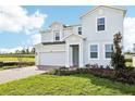 Two-story house with a gray exterior and brick driveway at 27472 Black Kite Ave, Howey In The Hills, FL 34737