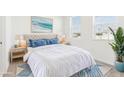 Spacious bedroom with a plush bed and ocean-themed art at 27472 Black Kite Ave, Howey In The Hills, FL 34737