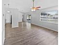 Spacious living room featuring wood-look floors and access to patio at 5119 Timber Ridge Trl, Ocoee, FL 34761