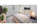 Cozy bedroom with light walls, a queen bed, and wood-look floors at 5119 Timber Ridge Trl, Ocoee, FL 34761