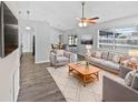 Bright living room with comfy seating and wood-look floors at 5119 Timber Ridge Trl, Ocoee, FL 34761