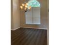 Formal dining room with a chandelier and large window at 519 Lakescape Ct, Orlando, FL 32828