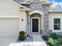 Inviting front entrance with stone detailing at 5364 Ragusa Loop, Saint Cloud, FL 34771