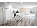Modern kitchen featuring white cabinets, stainless steel appliances, and granite countertops at 8969 Sheppard Dr, Lake Wales, FL 33898