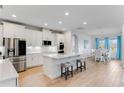 Modern kitchen with white cabinets, quartz countertops, and stainless steel appliances at 9849 Lost Creek Dr, Winter Garden, FL 34787