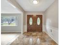 Bright entryway with tiled floors and double doors at 1215 Waverly Way, Longwood, FL 32750