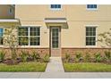 Front entrance with stone base and landscaping at 141 Holly Village Dr, Davenport, FL 33837