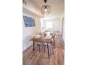 Modern dining area with wood table and contemporary lighting at 2129 E Esther St, Orlando, FL 32806