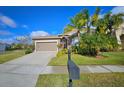 Attractive home with a two-car garage, palm trees, and well-manicured lawn at 2530 Carrickton Cir, Orlando, FL 32824