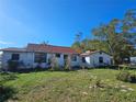 Ranch style home with red tile roof and a spacious yard at 3250 Mountain Lake Cutoff Rd, Lake Wales, FL 33859
