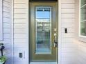 Modern front door with glass panels and keyless entry system at 349 Alcove Dr, Groveland, FL 34736