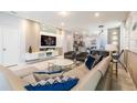 Open living room with modern furniture and a large TV at 7400 Oakmoss Loop, Davenport, FL 33837