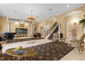 Grand living room with ornate furnishings and a sweeping staircase at 7440 Aloma Ave, Winter Park, FL 32792