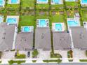 Community with houses, pools, and lush green landscaping at 7766 Westland Dr, Kissimmee, FL 34747