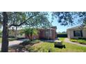 House exterior with orange walls, landscaping, and a driveway at 836 Grand Canal Dr, Kissimmee, FL 34759