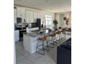 Spacious kitchen with an island, white cabinets, and granite countertops at 8918 Tropical Haven Ct, Kissimmee, FL 34747