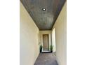 Covered entryway with wood-paneled ceiling and brick flooring at 16779 Broadwater Ave, Winter Garden, FL 34787