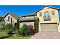 Two-story home with stone accents and a three-car garage at 16779 Broadwater Ave, Winter Garden, FL 34787