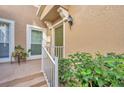 Green front door with white railings and potted plants at 2847 Metro Sevilla Dr # 105, Orlando, FL 32835