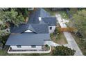 Newly renovated house with a black roof and a fenced yard at 1009 Herndon St, Leesburg, FL 34748
