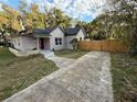 Newly renovated house with a red door, walkway, and driveway at 1009 Herndon St, Leesburg, FL 34748