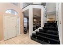 Bright entryway with a grand staircase and tiled flooring at 1349 Castleport Rd, Winter Garden, FL 34787