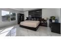 Spacious bedroom with large window, tiled floor, and a black headboard at 1349 Castleport Rd, Winter Garden, FL 34787