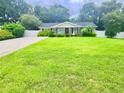 House exterior with green lawn and trees at 2102 Mckinnon St, Mascotte, FL 34753