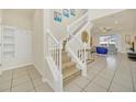 Bright entryway with white staircase, wooden flooring, and built-in shelving at 2468 Dubai St, Kissimmee, FL 34747