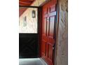 Condo entryway with a red door, providing a warm welcome into the unit at 2850 N Powers Dr # 9, Orlando, FL 32818