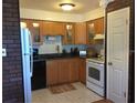 Modern kitchen featuring wood cabinets, granite countertops, and a full suite of appliances at 616 Georgetown Dr # B, Casselberry, FL 32707