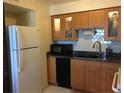 Updated kitchen with wood cabinets, granite counters, and stainless steel appliances at 616 Georgetown Dr # B, Casselberry, FL 32707
