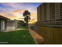 Charming home with a backyard, canal views, and a grassy area at 213 Sandy Cir, South Daytona, FL 32119