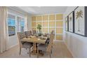 Bright dining room features a wood table, gray chairs, and an accent wall at 4201 Singing Mockingbird Blvd, Bartow, FL 33830