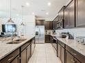Modern kitchen with stainless steel appliances and granite countertops at 617 Jasmine Ln, Davenport, FL 33897